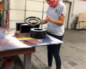 Thompson School District female intern working on a project at manufacturing facility.