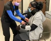 Female medical assistant apprentice helping an injured woman