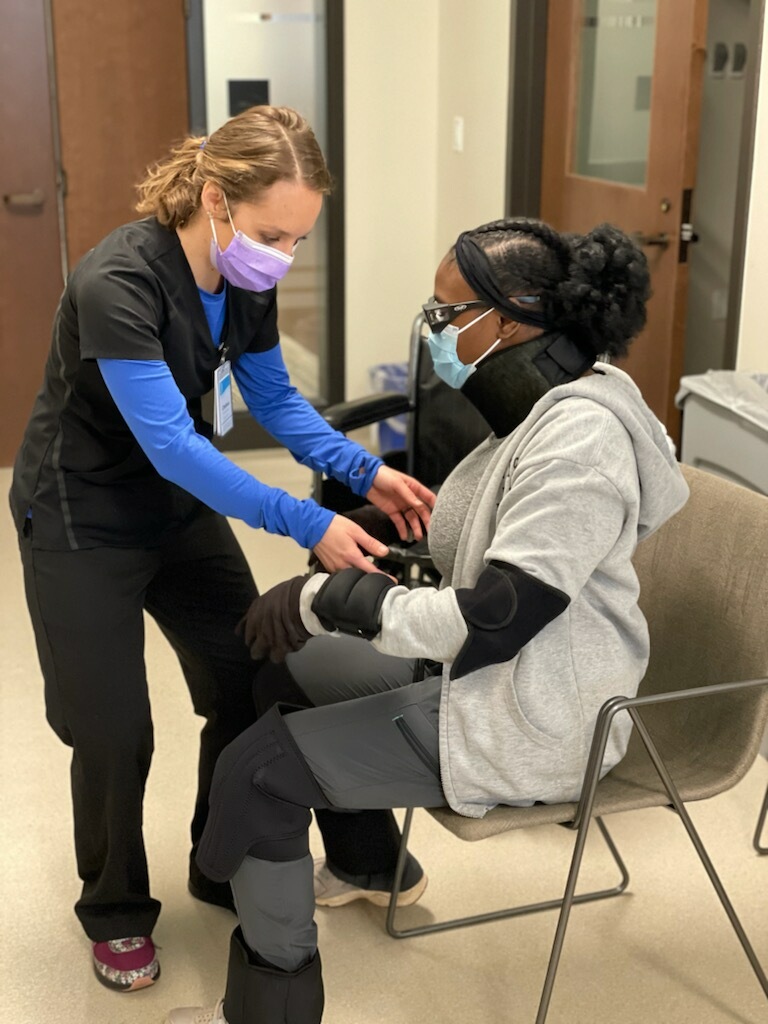 Female medical assistant apprentice helping an injured woman