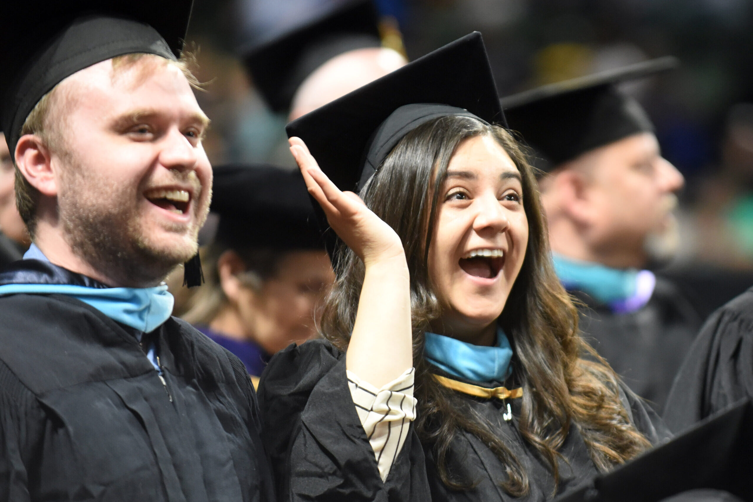 generic-image-2 Female and male college students celebrating at graduation.