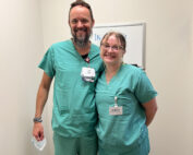 Youth Health Sector Partnership female intern in scrubs posing with medical supervisor in scrubs.