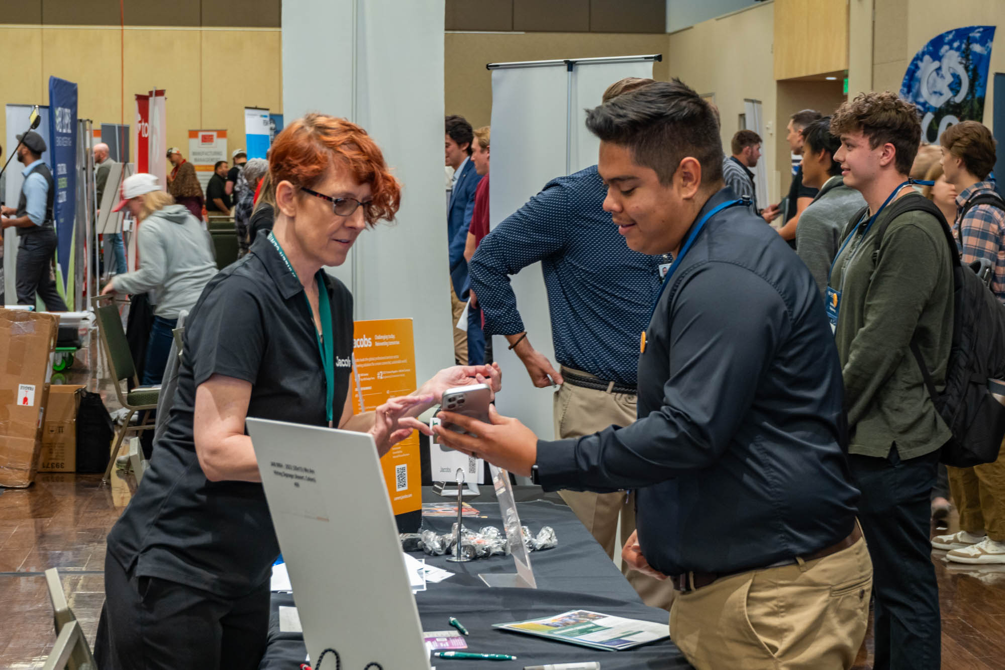 Student and business recruiter talking at Colorado State University career fair.